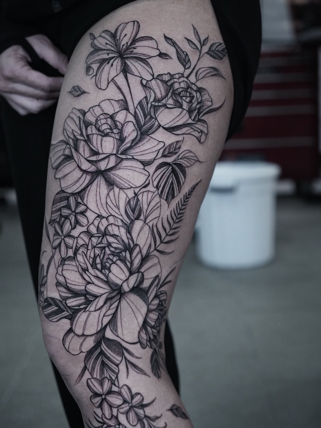 Floral bouquet black and grey tattoo on the thigh by Tattoo Ottawa