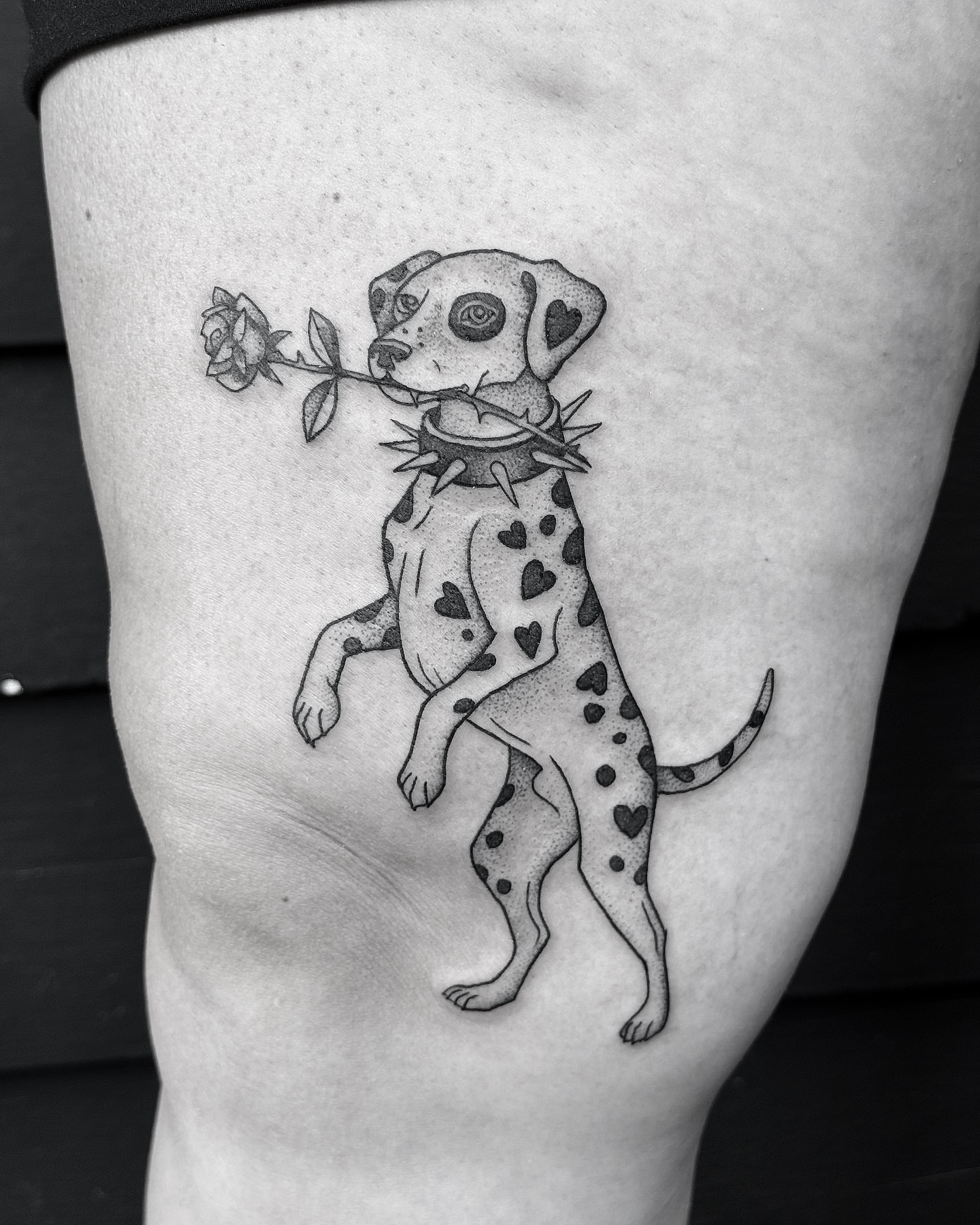 Dalmatian with rose realism tattoo on the thigh by Breezy Tucker
