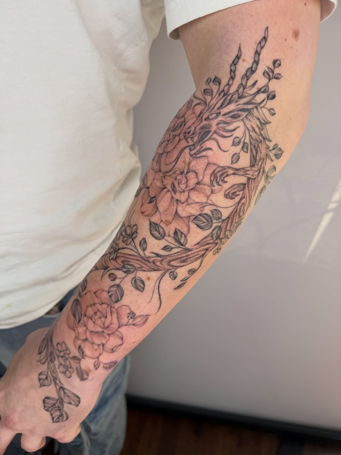 Floral deer realism tattoo on the forearm by Brandie