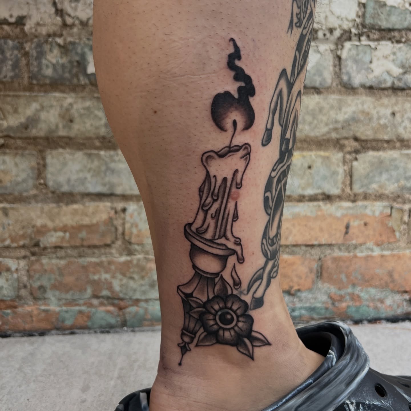 Candle and flower American traditional tattoo on the calf by Lauren