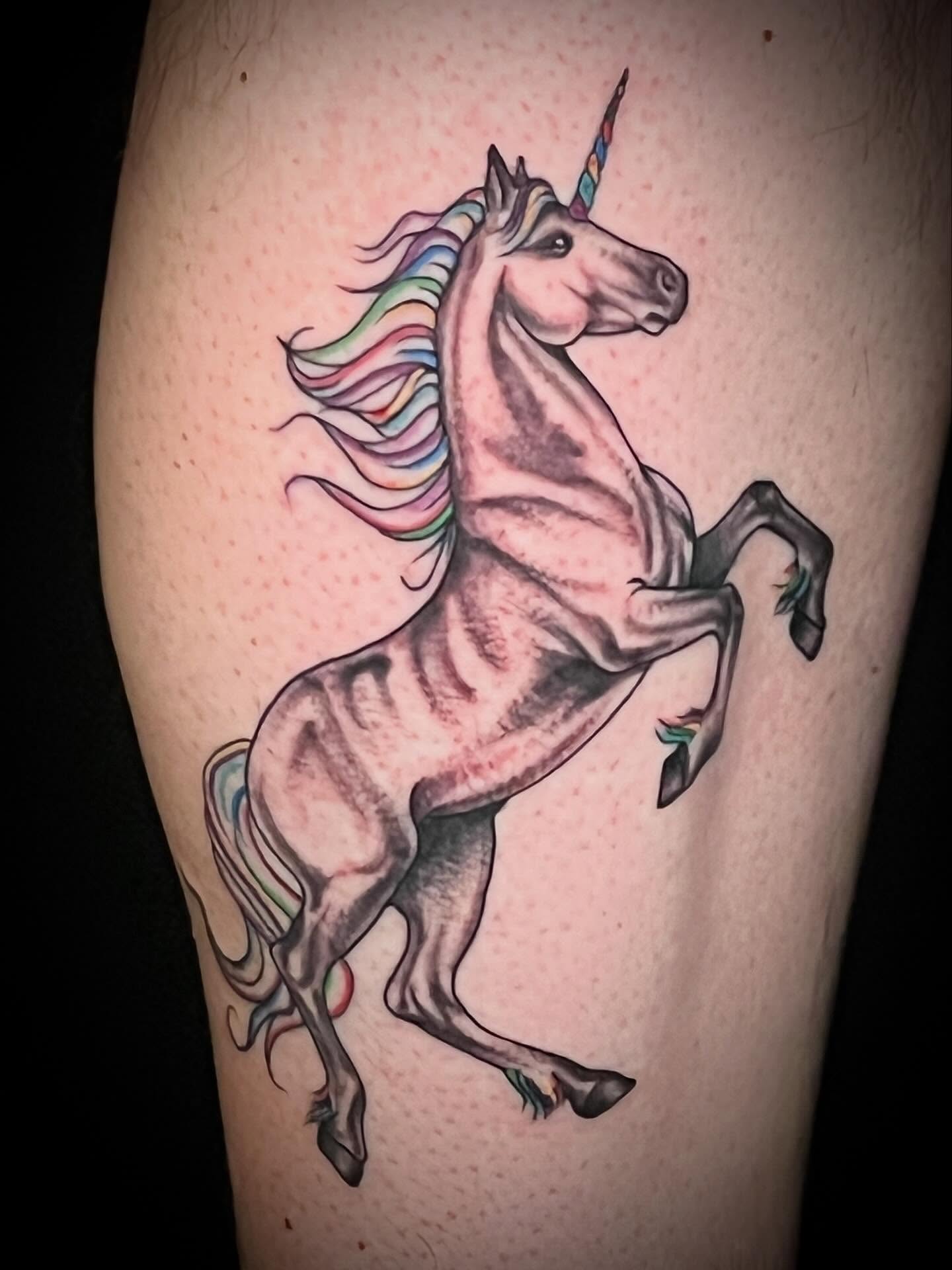 Unicorn realism tattoo on the thigh by Suzanne B
