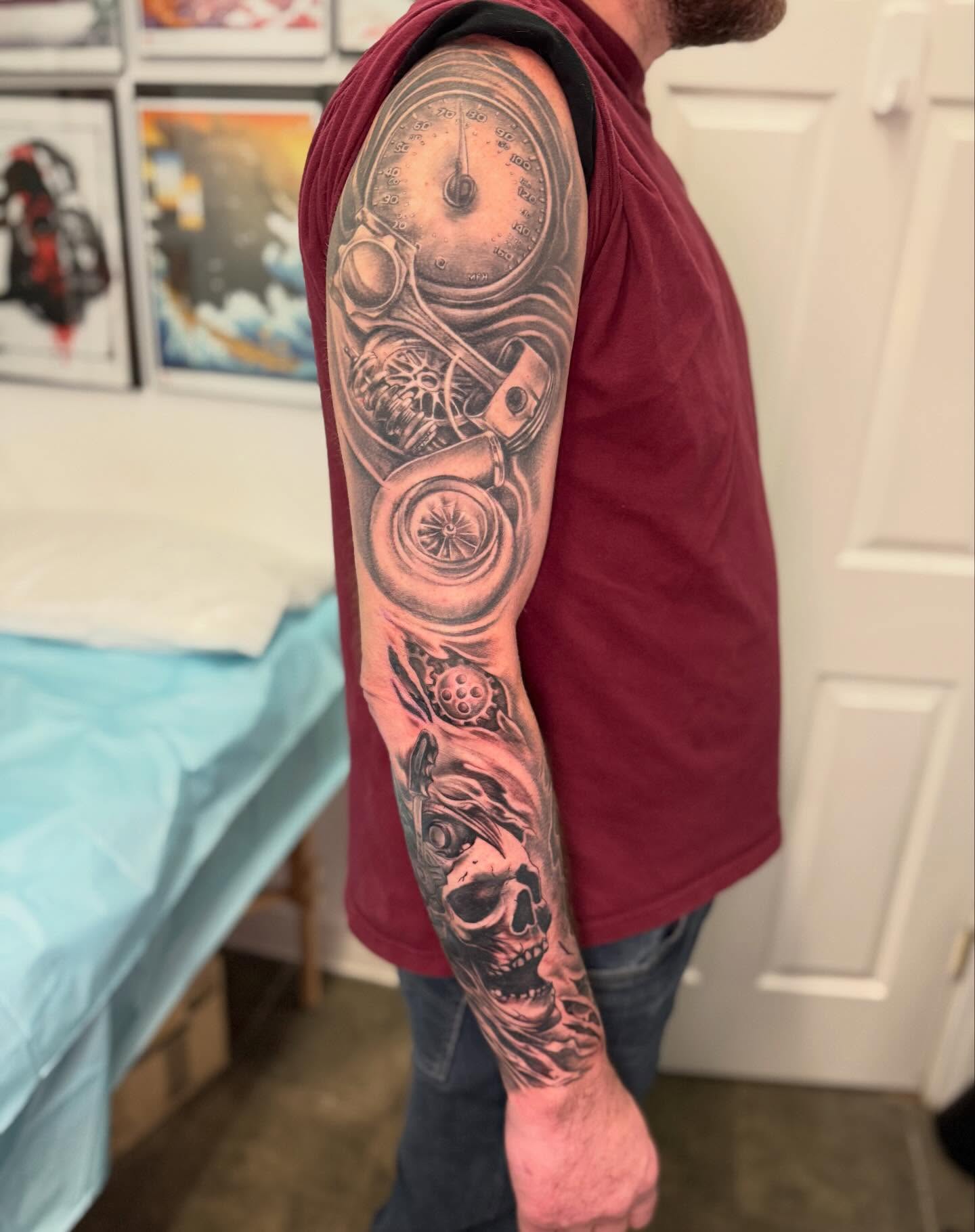 Motorcycle and skull realism tattoo on the upper arm by Vega