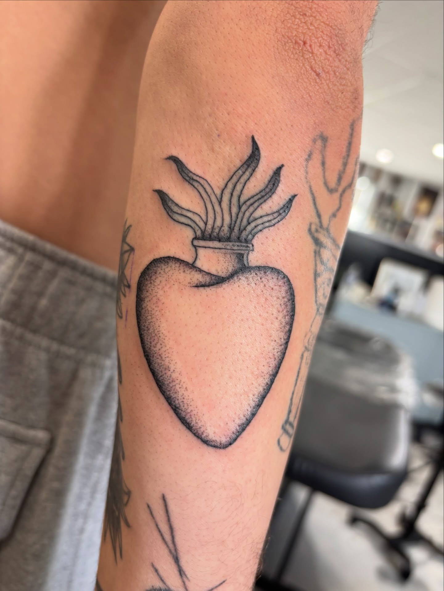 Heart with plant dotwork tattoo on the forearm by Miklo Montoya