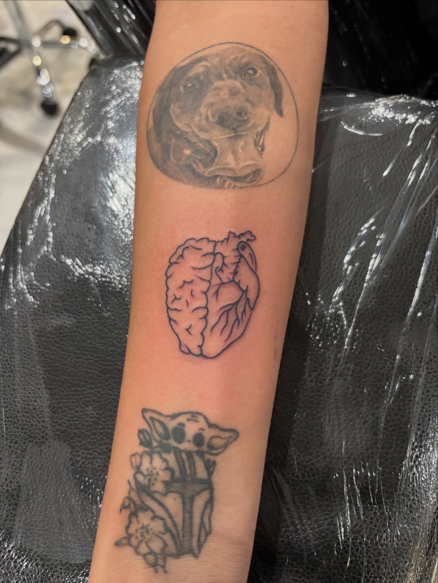 Dog, heart, baby yoda realism tattoo on the forearm by Miklo Montoya