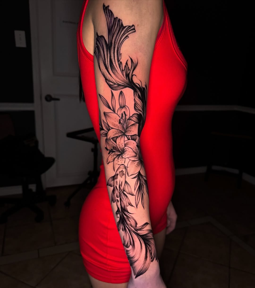 Koi fish and lilies fine line tattoo on the forearm by Tattoo Artist based in Dallas Tx