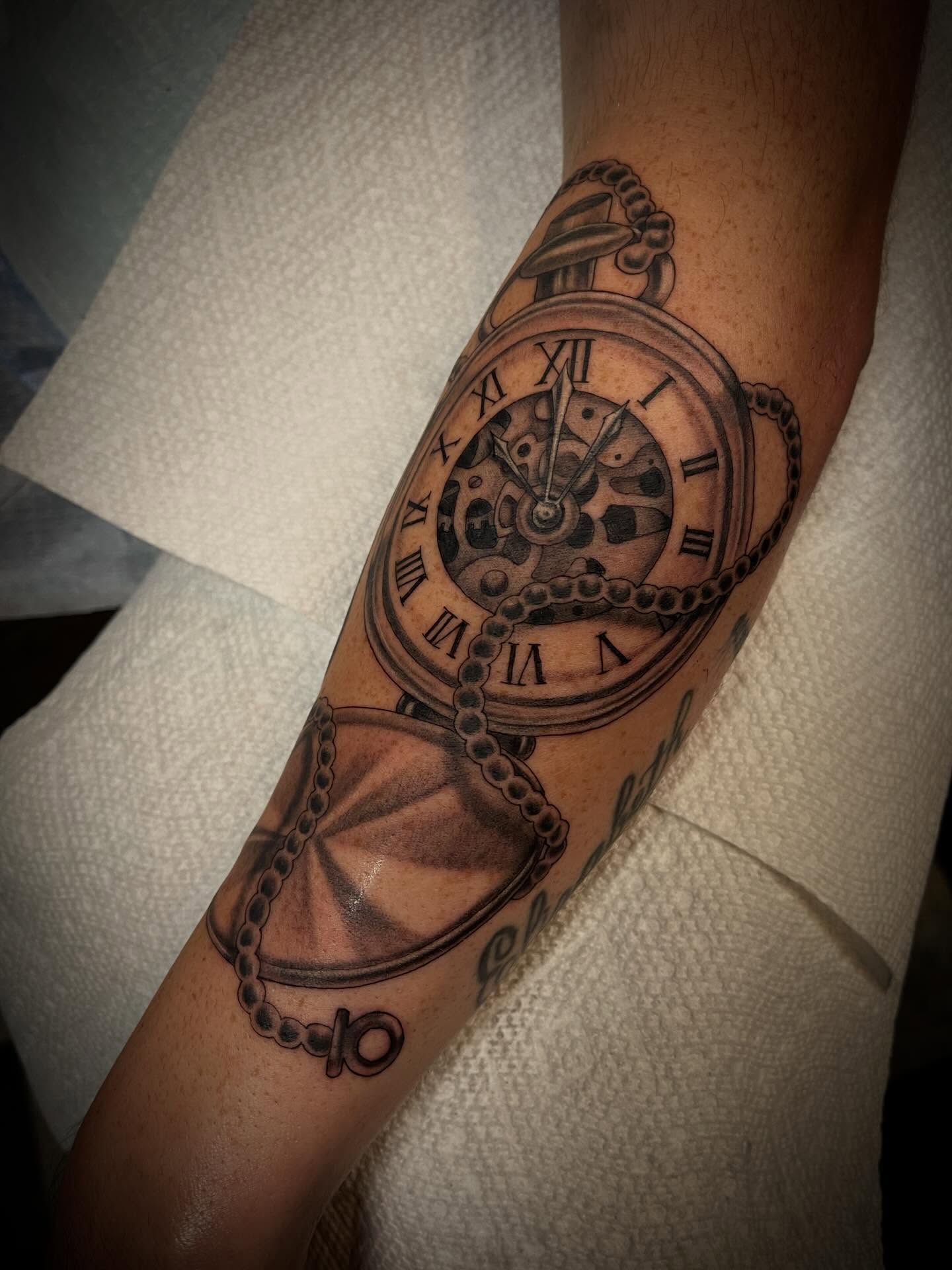 Pocket watch black and grey tattoo on the forearm by Jacob Finelli