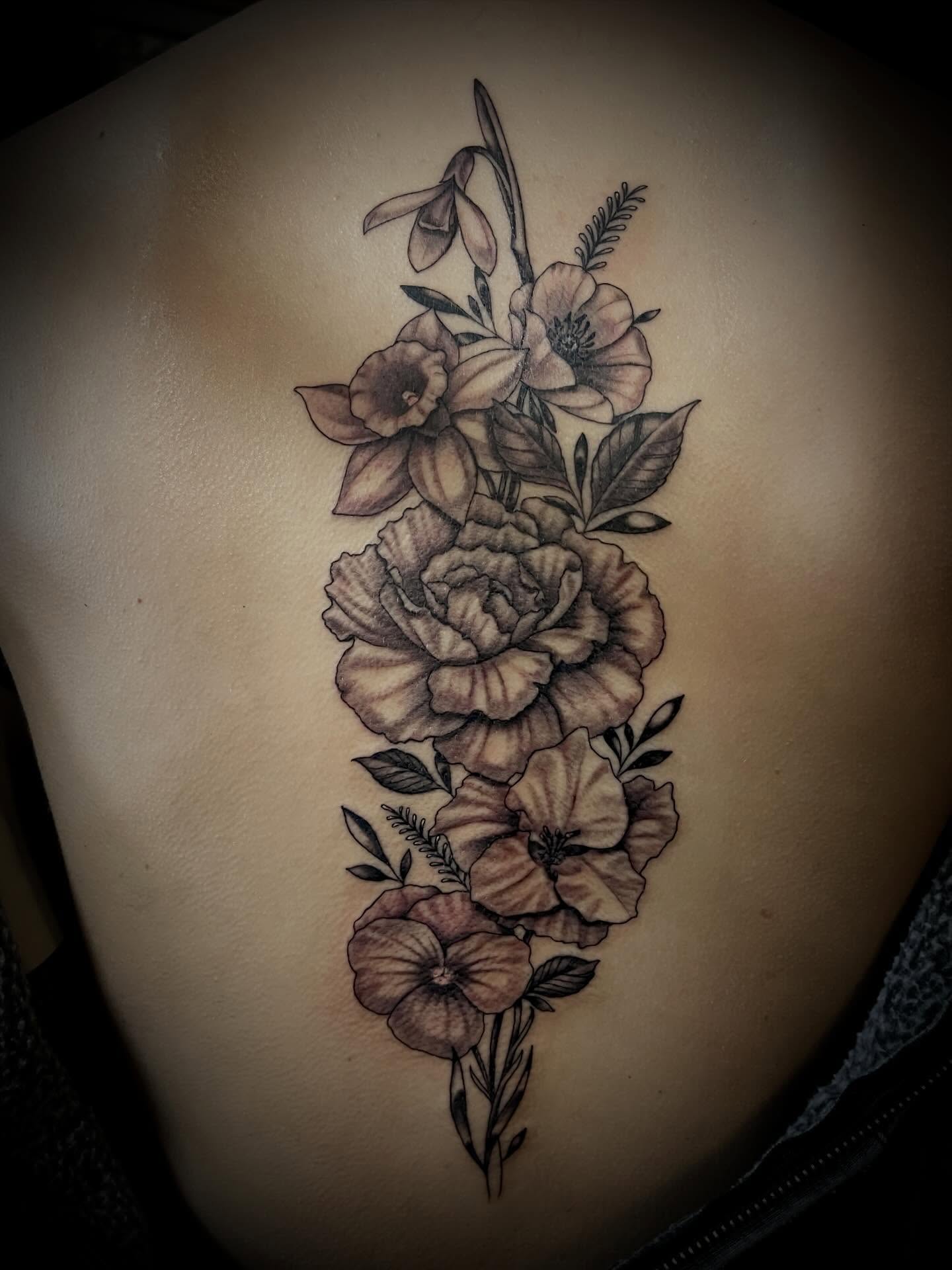 Floral bouquet black and grey tattoo on the back by Jacob Finelli