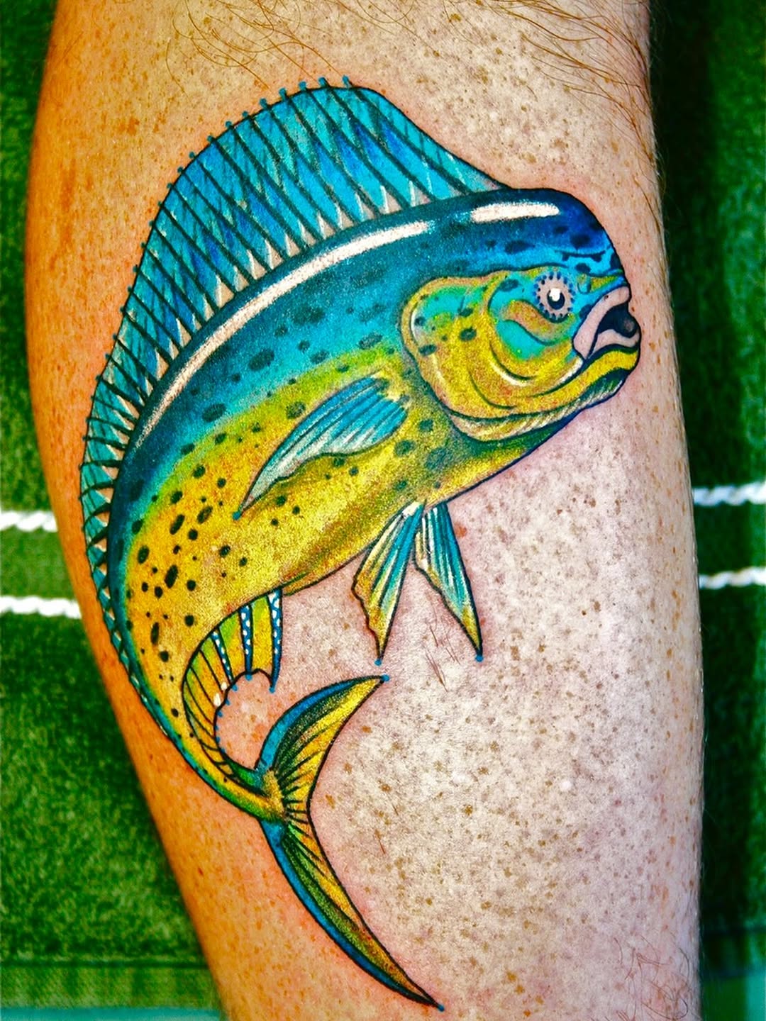 Mahi-mahi fish new school tattoo on the forearm by @colorrobbie
