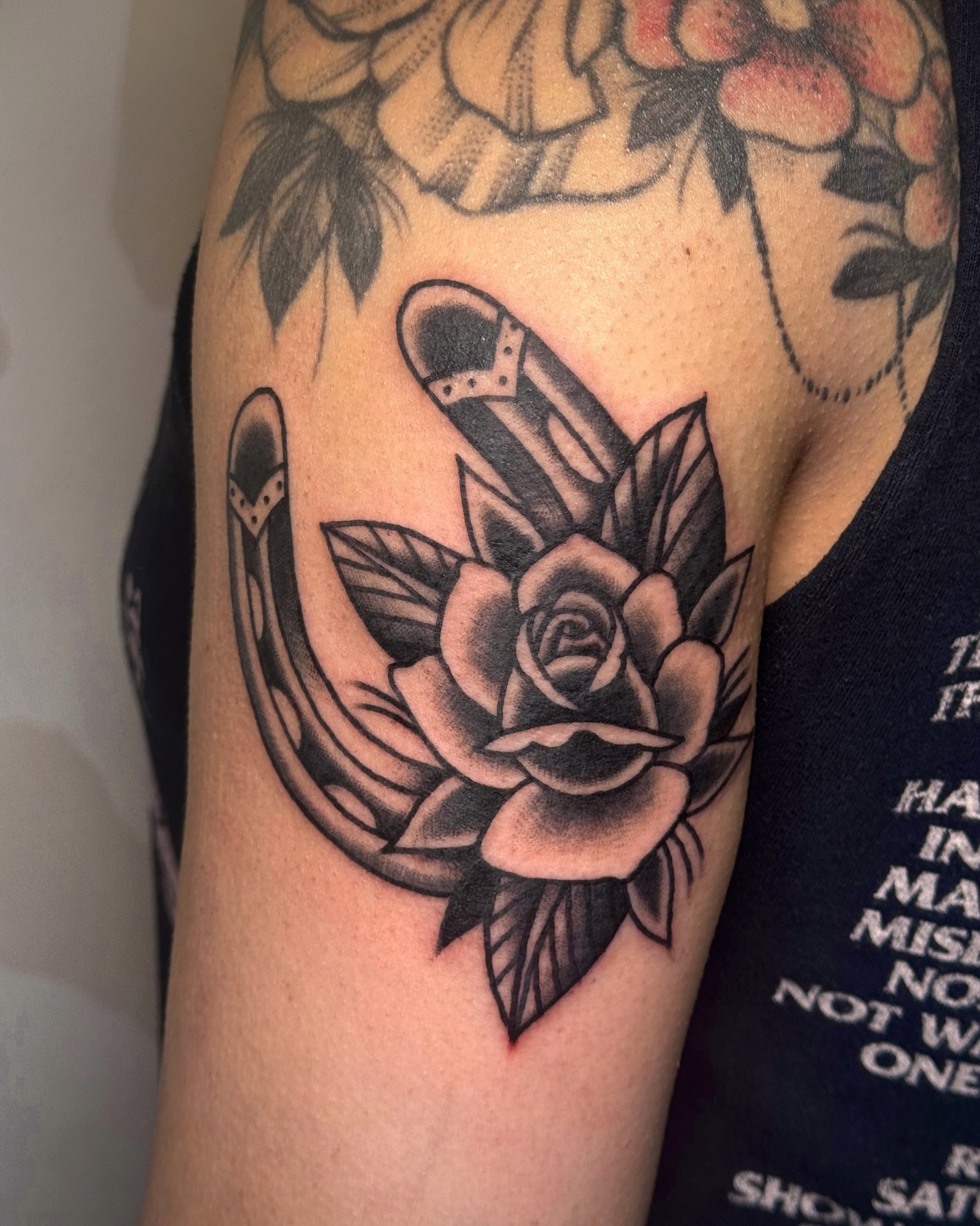 Rose and shoe American traditional tattoo on the forearm by Bre Grover, Vancouver, British Columbia