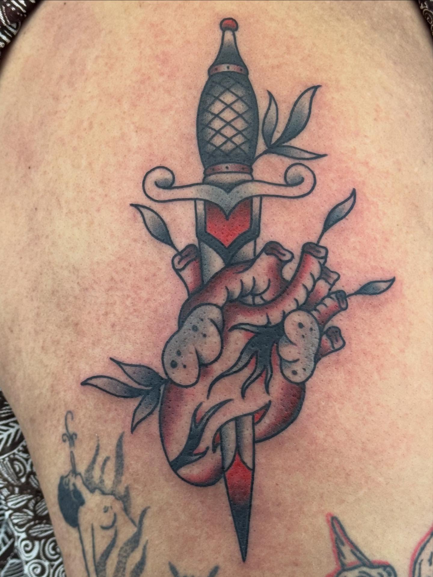 Heart pierced by dagger American traditional tattoo on the torso by π©πͺπ¬