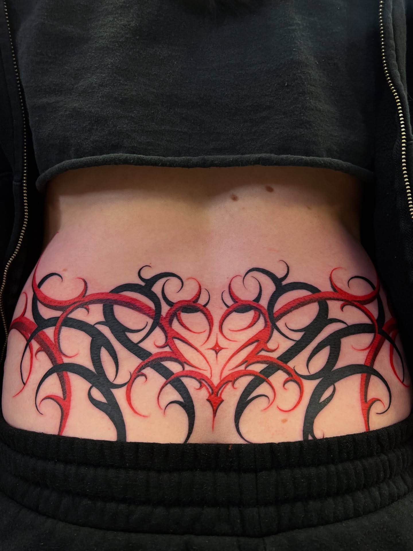 Tribal heart tribal tattoo on the torso by Lettering