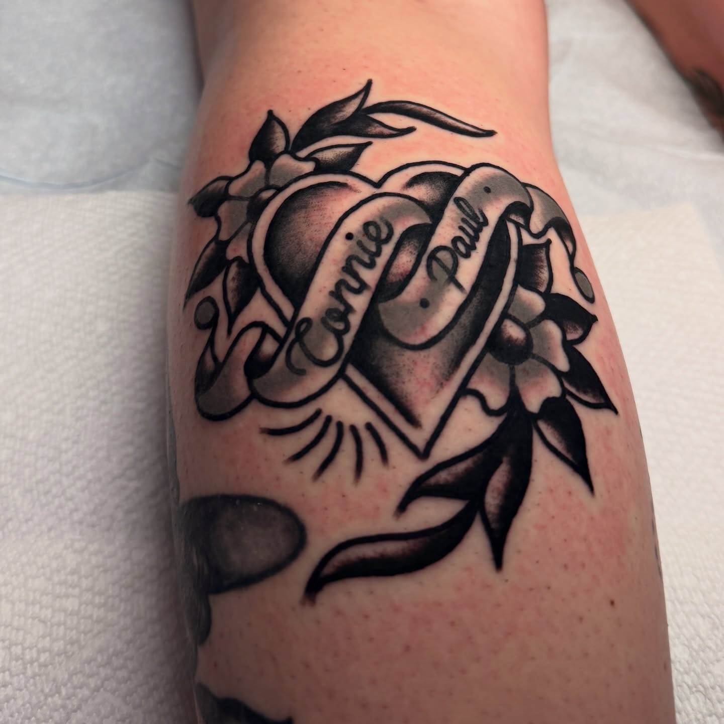 Heart with ribbon American traditional tattoo on the forearm by Stevie Lowenstein, Cincinnati, Ohio