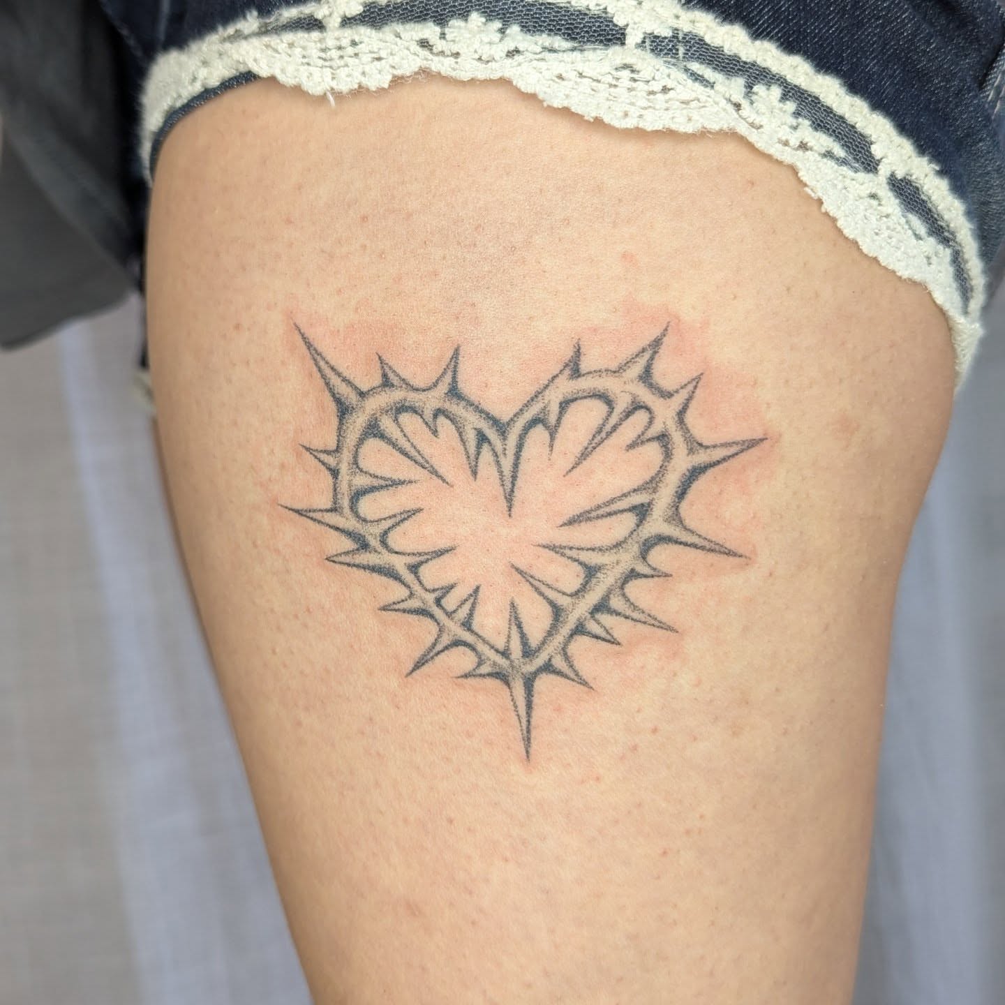 Heart with thorns black and grey tattoo on the thigh by theo, Portland, Oregon