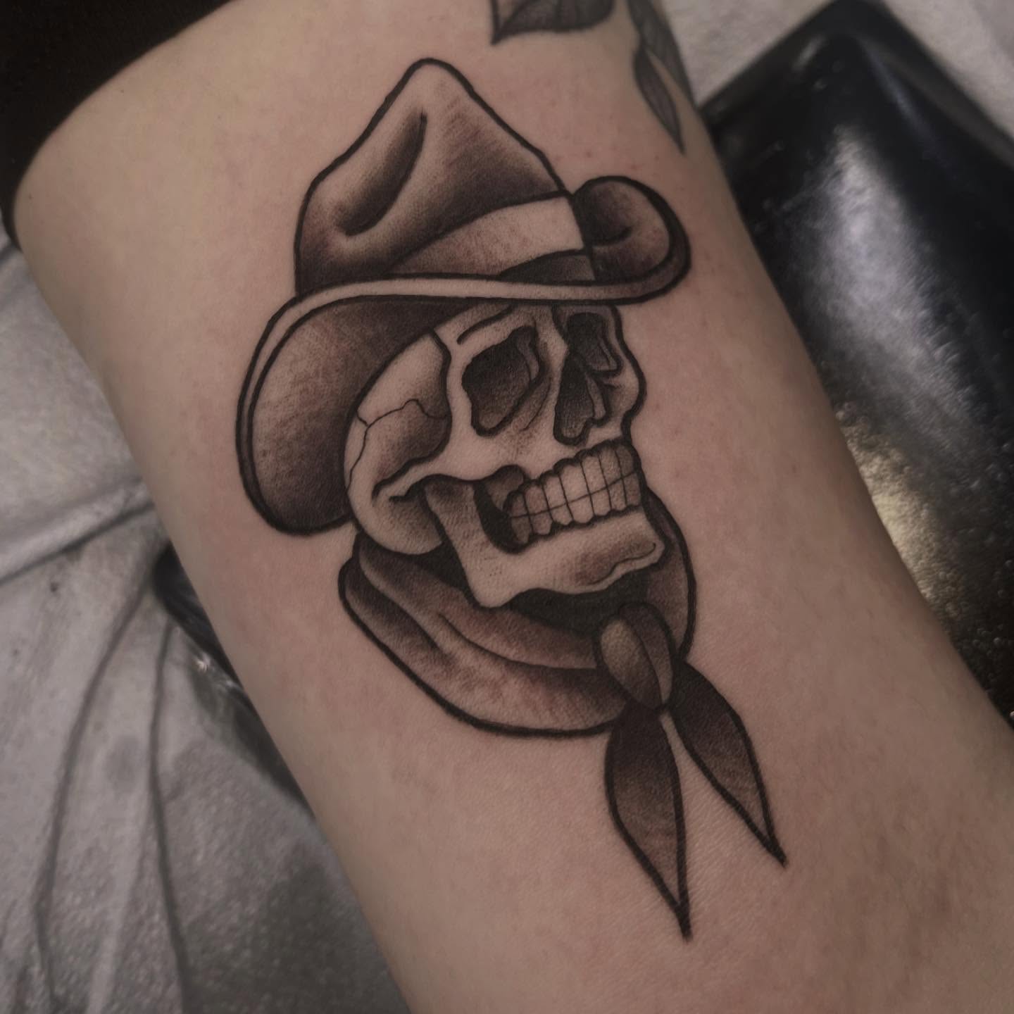 Skull wearing hat American traditional tattoo on the forearm by Sarah Foltz