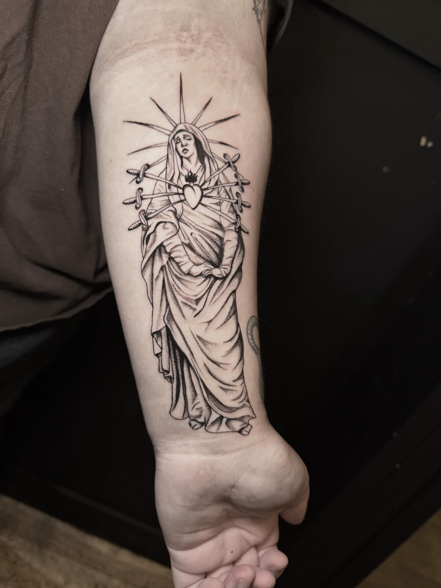 Religious figure black and grey tattoo on the forearm by Jess, Midvale, Utah