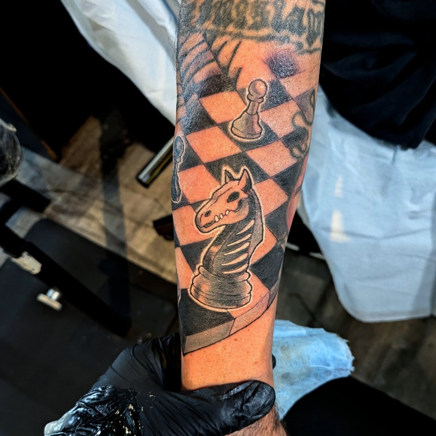 Chessboard black and grey tattoo on the forearm by Lahel (Lay-el) Fowler
