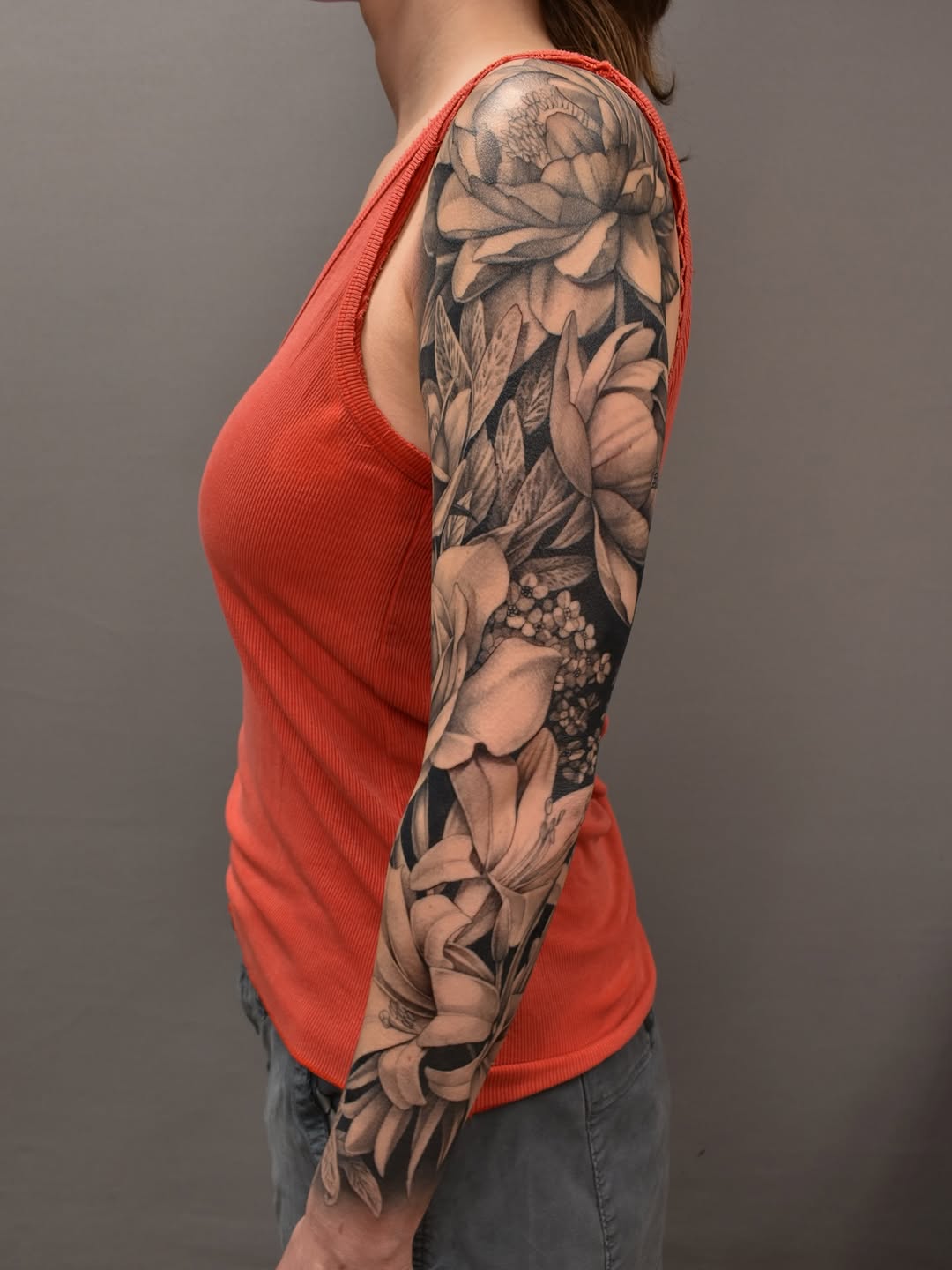 Floral sleeve fine line tattoo on the upper arm by Tattoo Artist