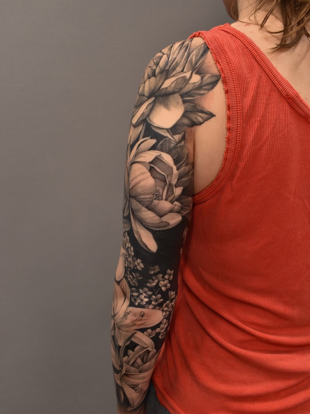 Floral sleeve fine line tattoo on the upper arm by Tattoo Artist