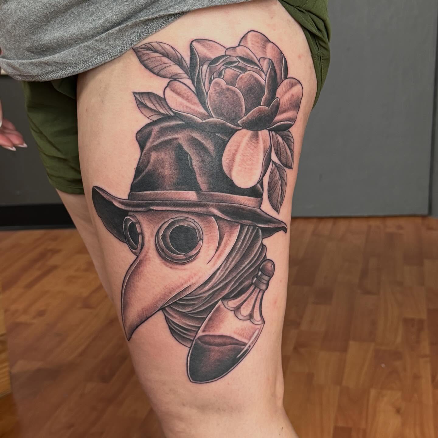 Plague doctor mask with flower realism tattoo on the thigh by Matt Hattaway