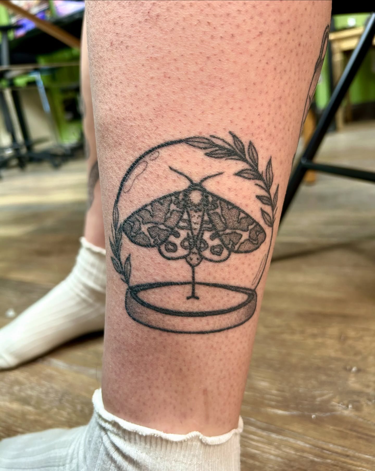 Moth black and grey tattoo on the calf by Courtney