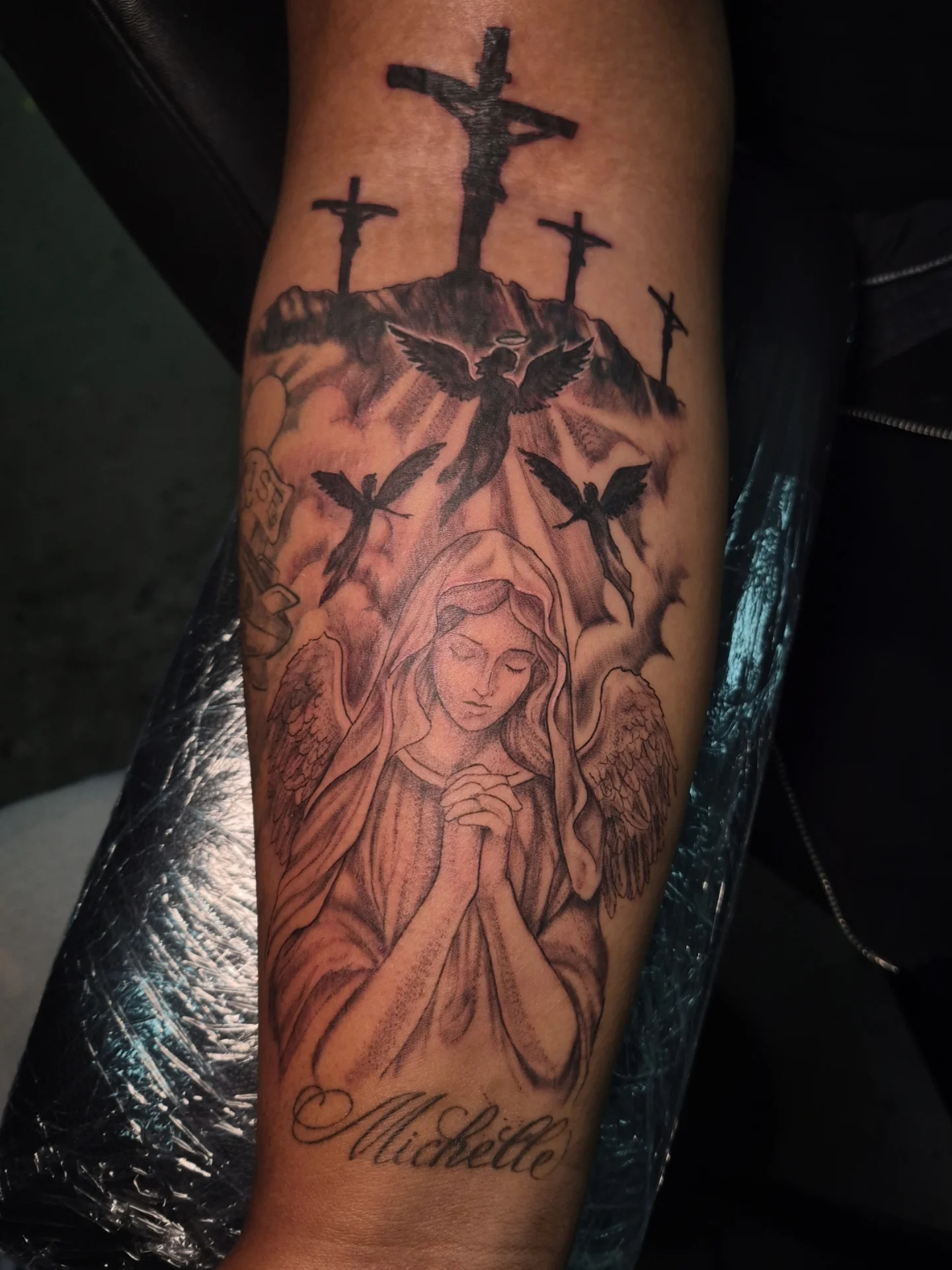 Religious angel realism tattoo on the forearm by Lydia Kiley