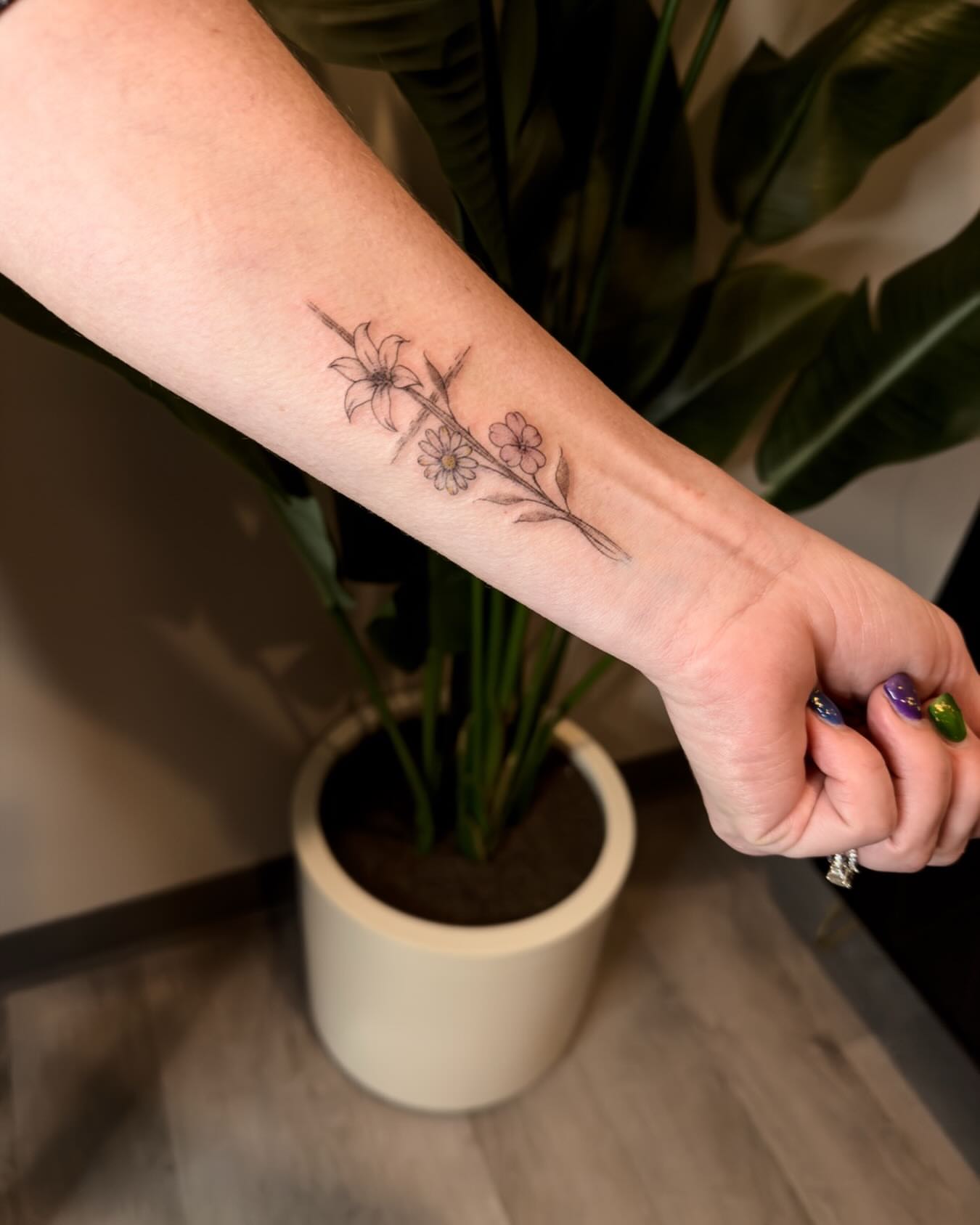 Flower branch black and grey tattoo on the forearm by Ashley Pilgreen