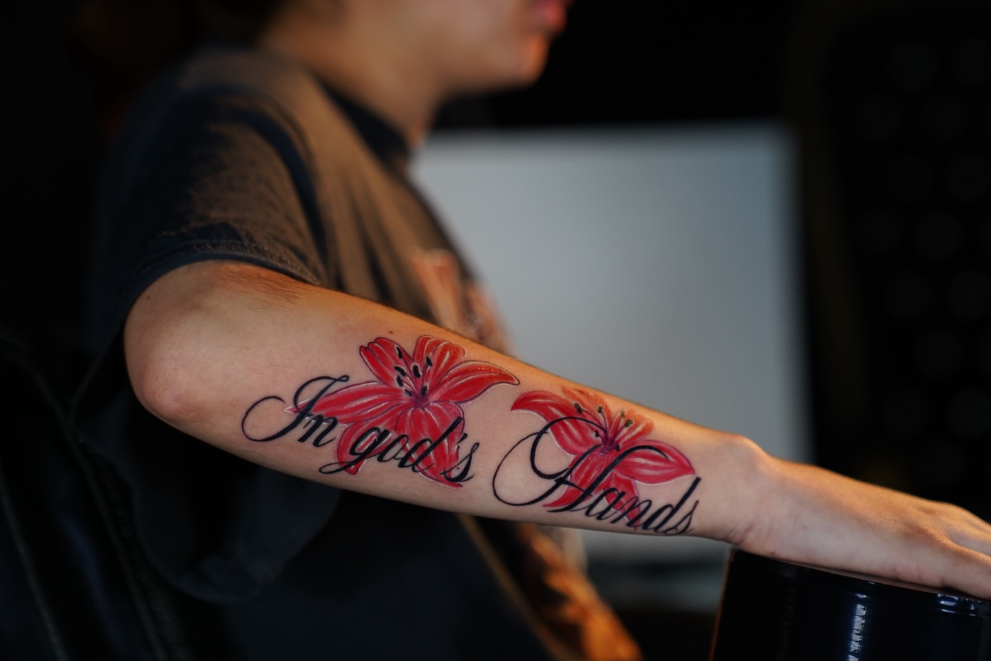 Lilies and script dotwork tattoo on the forearm by Elijah Tattoos, San Diego, California