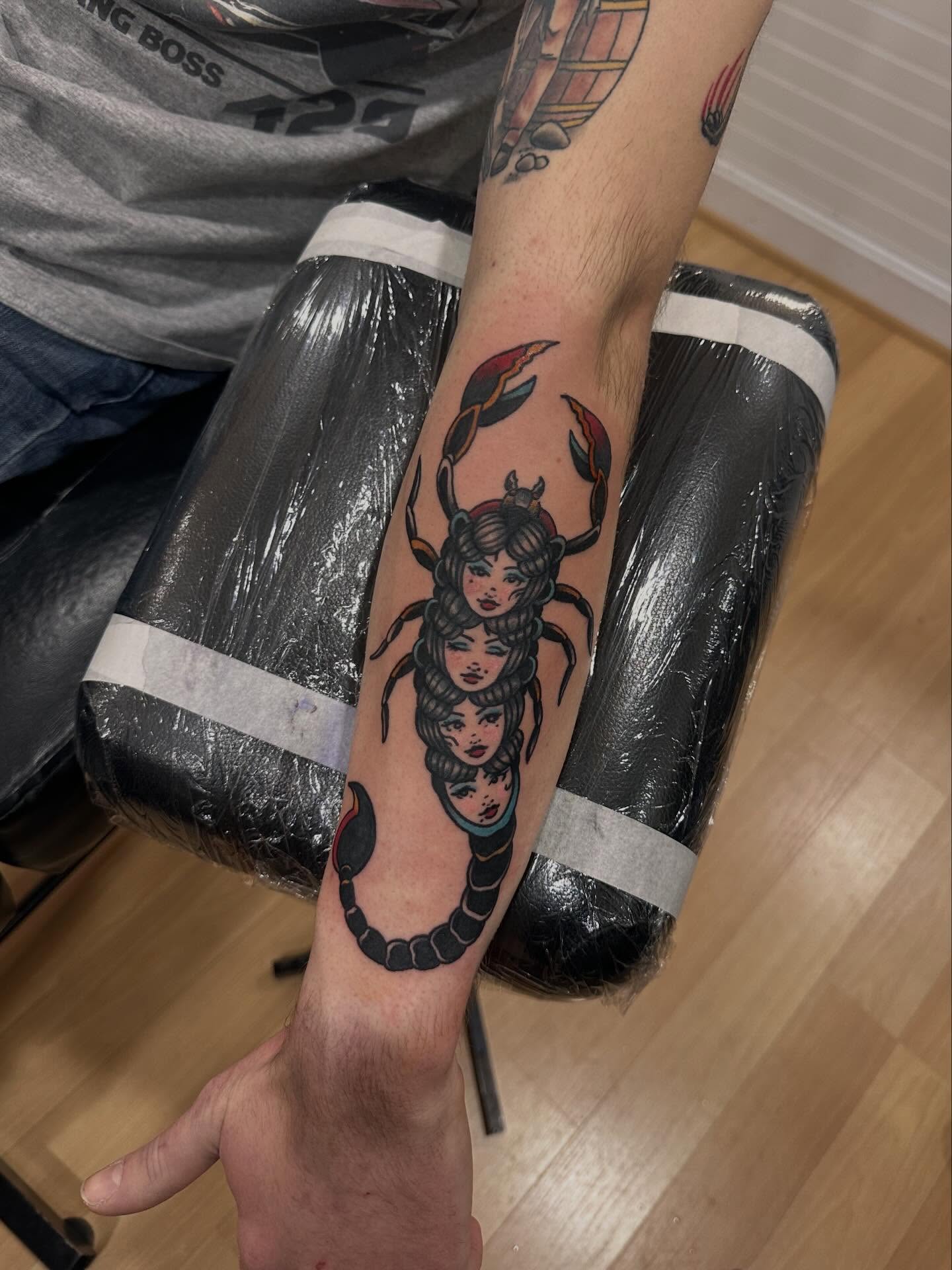 Scorpion with three heads American traditional tattoo on the forearm by Emma