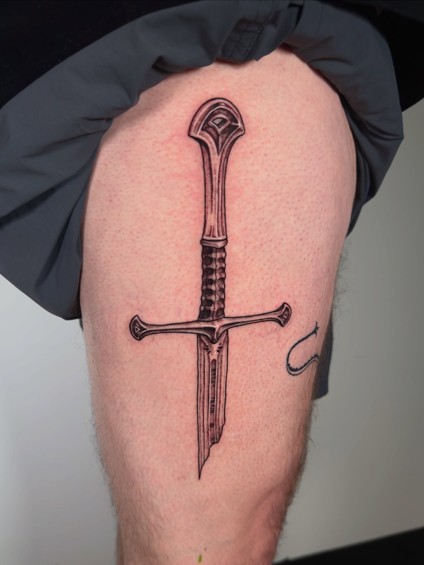 Sword black and grey tattoo on the thigh by Diana