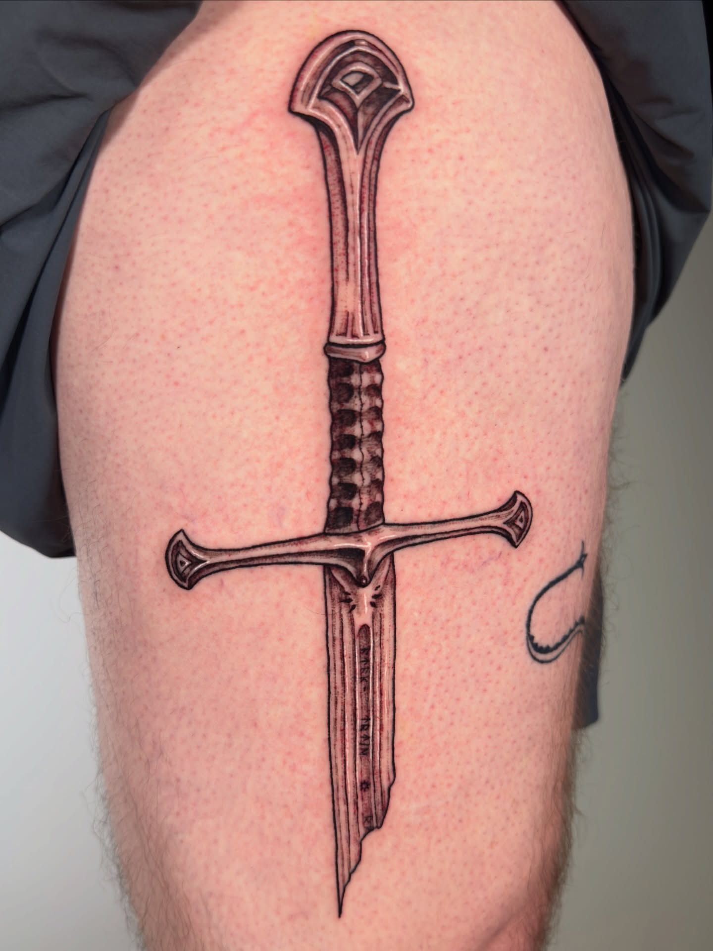 Sword black and grey tattoo on the thigh by Diana