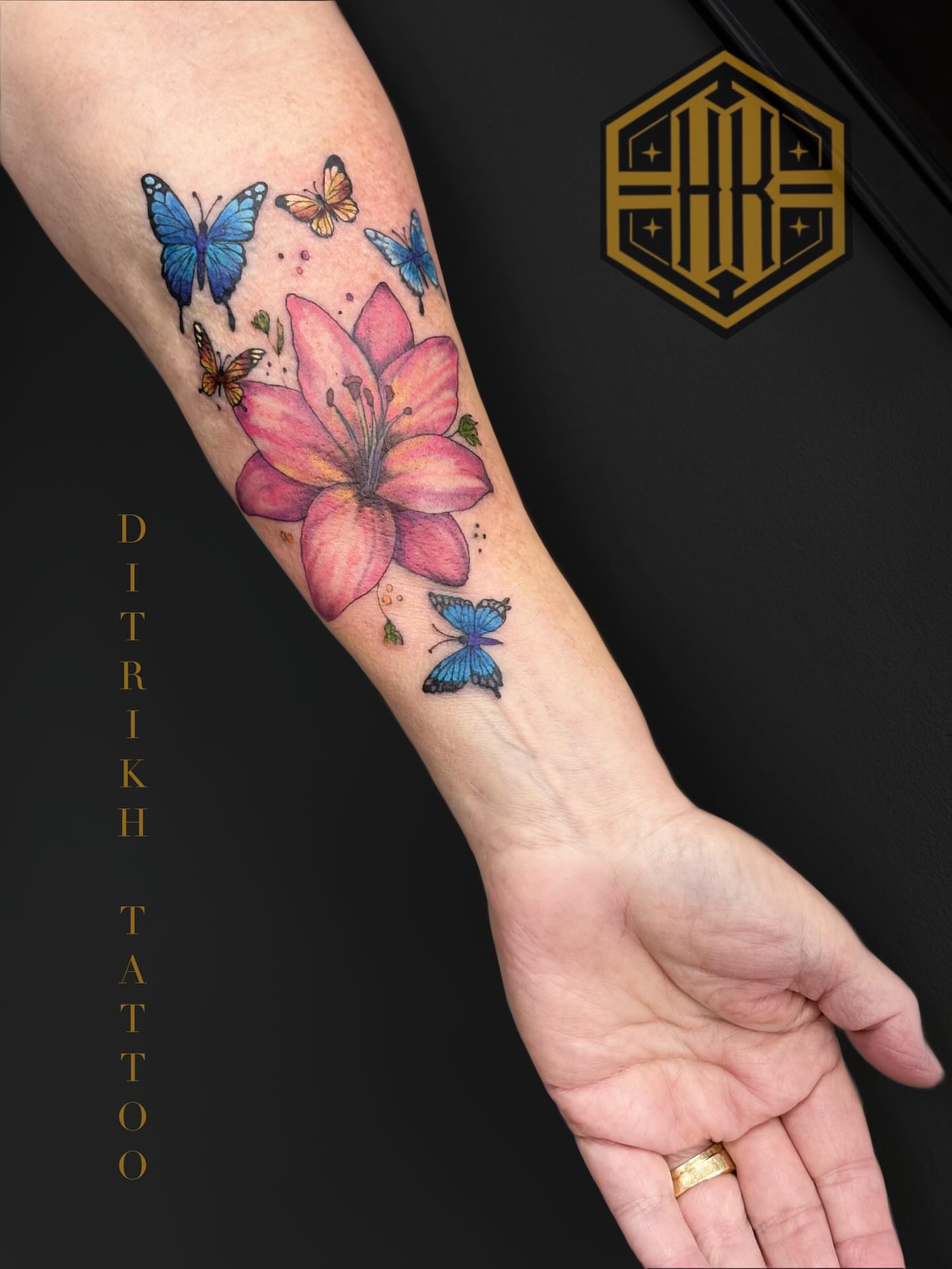 Lily and butterflies watercolor tattoo on the forearm by KET, Calgary, Alberta