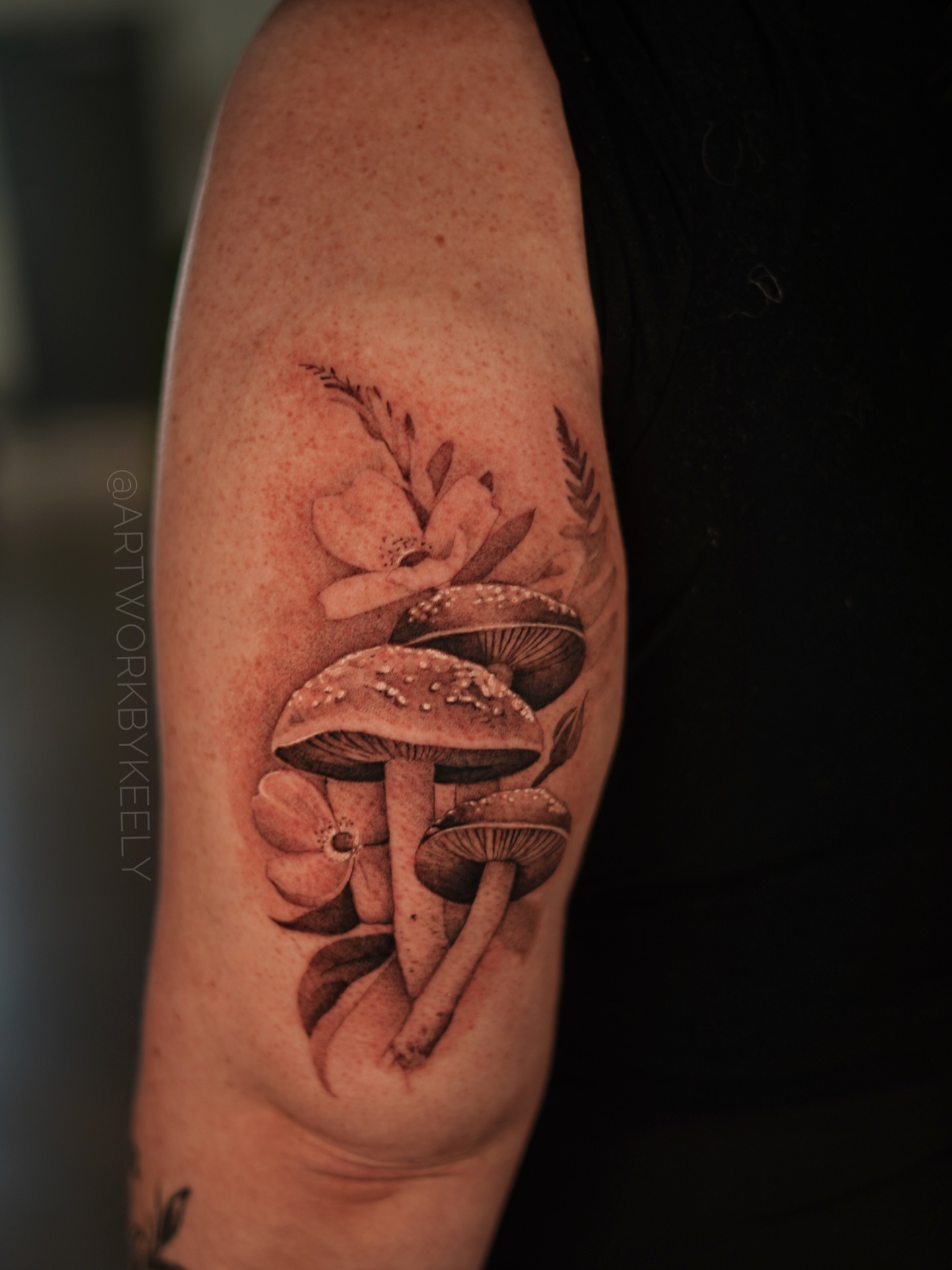 Mushroom cluster with flowers realism tattoo on the forearm by Keely Thompson
