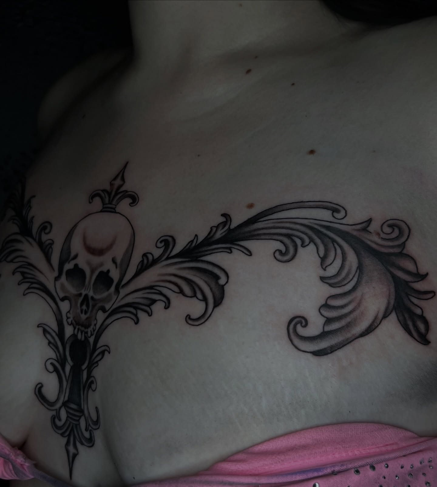 Skull and ornamental design ornamental tattoo on the chest by Vic Merkley