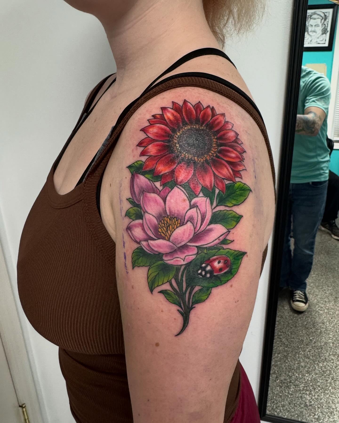 Sunflower and magnolia realism tattoo on the shoulder by Brazun Locker Poloschan