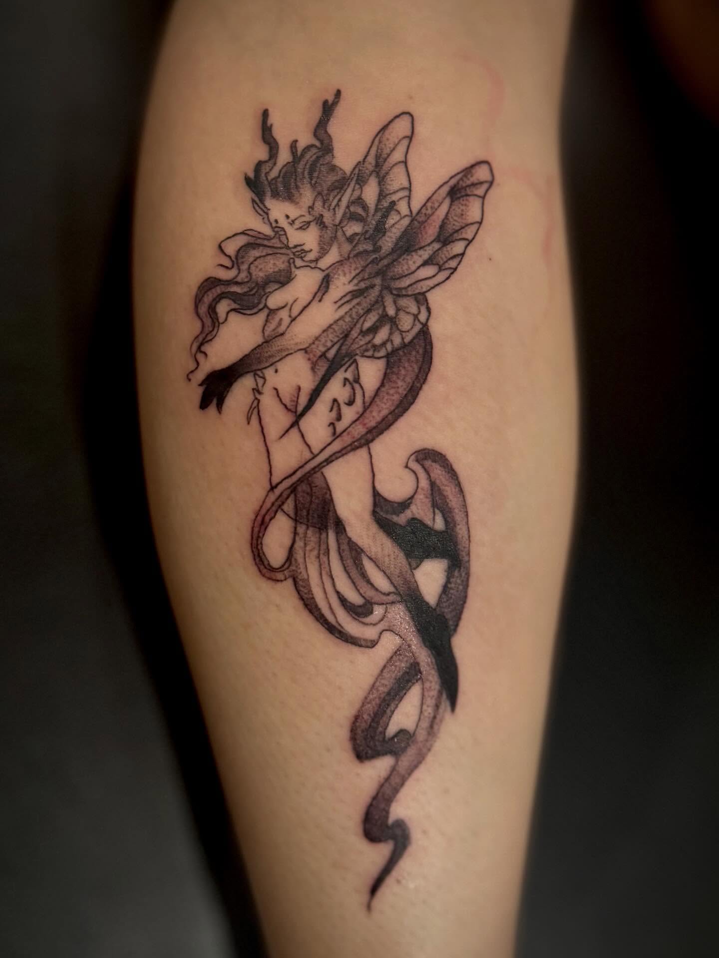 Fairy with snake black and grey tattoo on the forearm by Katelyn Arnold