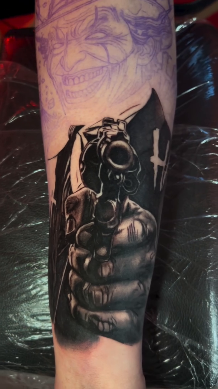 Hand holding a gun realism tattoo by Gage Cottrell