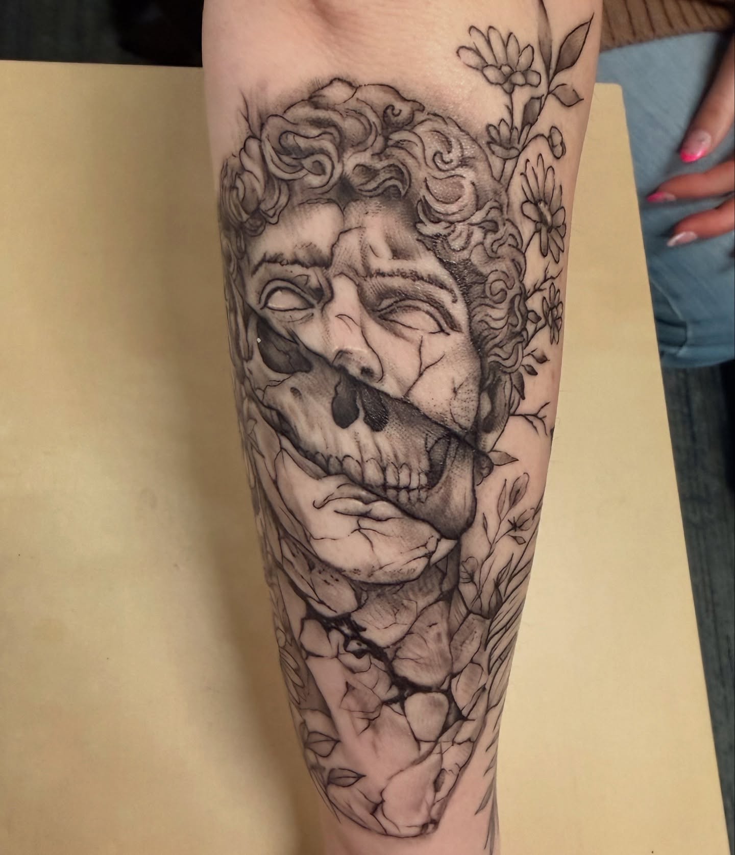 Skull with floral elements realism tattoo on the forearm by Timmy