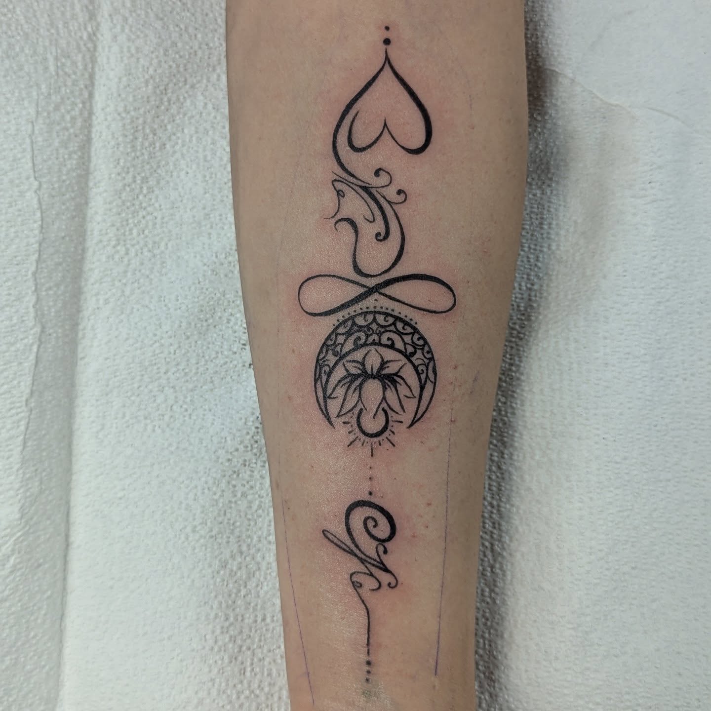 Heart and sun fine line tattoo on the forearm by DONEL 📍Denver