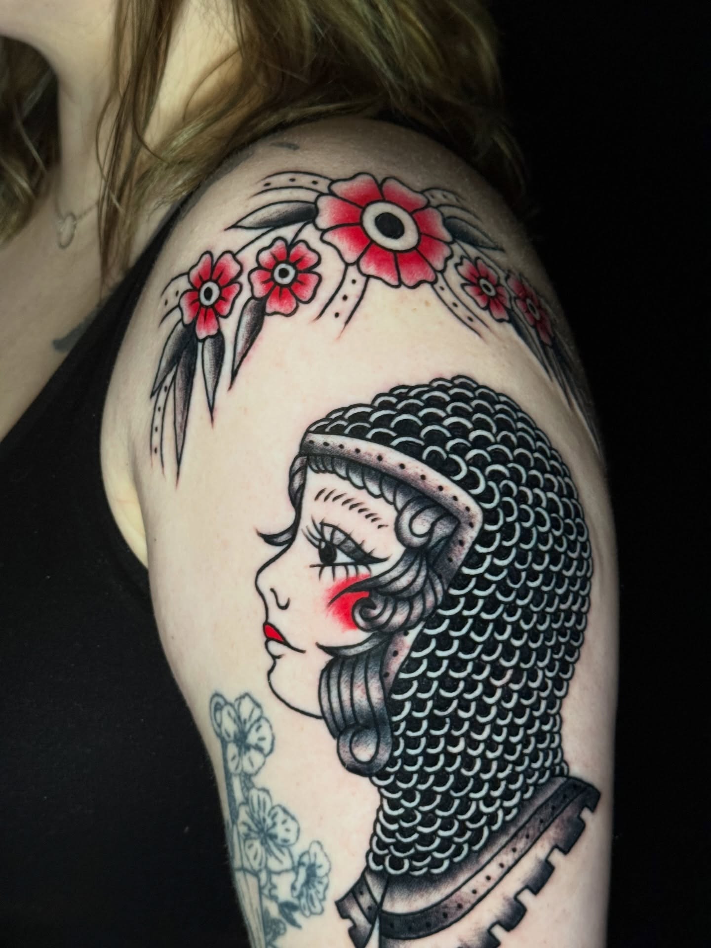 Woman with chainmail helmet American traditional tattoo on the shoulder by @ryanpereztattoo