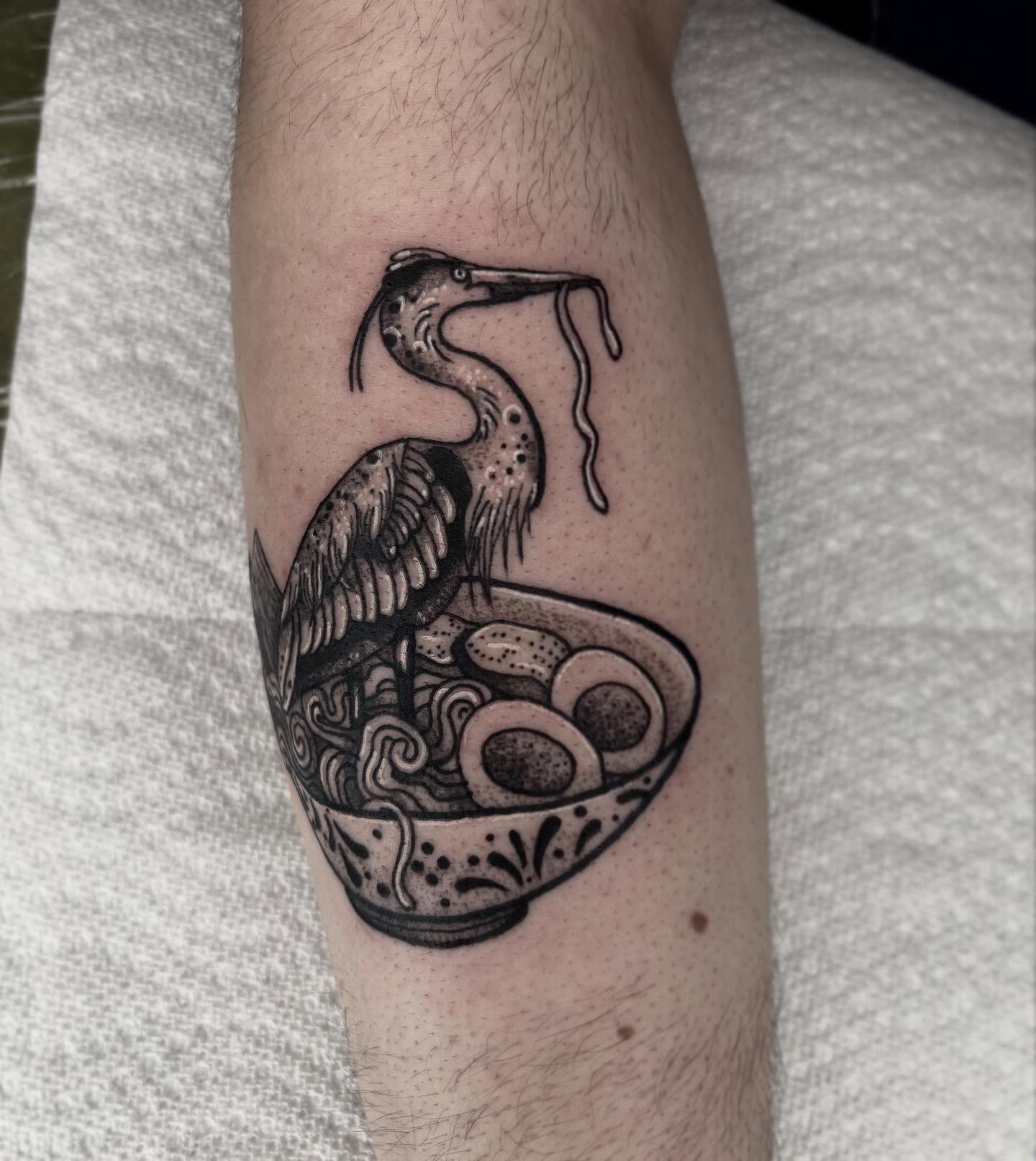Heron and ramen realism tattoo on the forearm by destiney rose