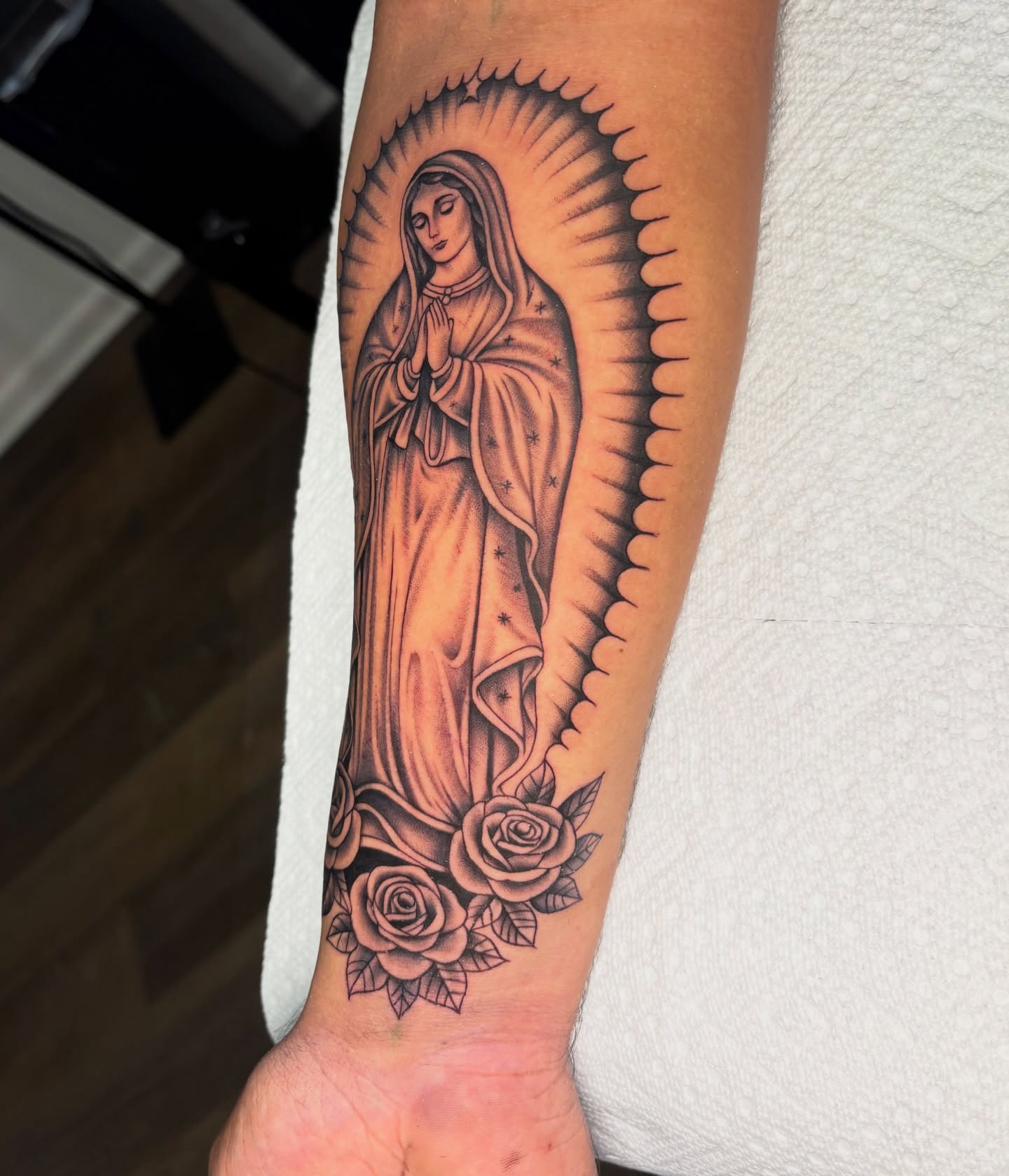 Our Lady of Guadalupe black and grey tattoo on the forearm by Osiel Rodriguez