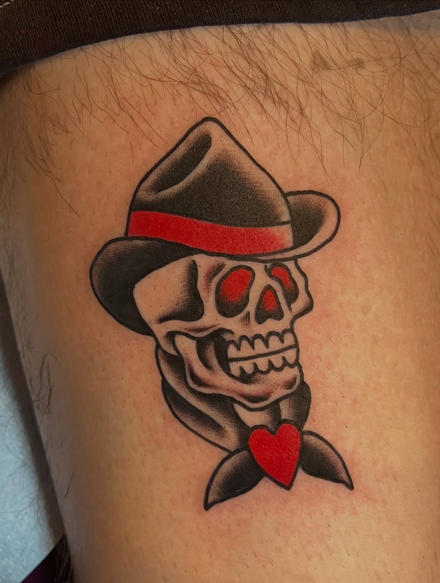 Skull wearing hat American traditional tattoo on the thigh by Anthony Tattooer, Seattle, Washington
