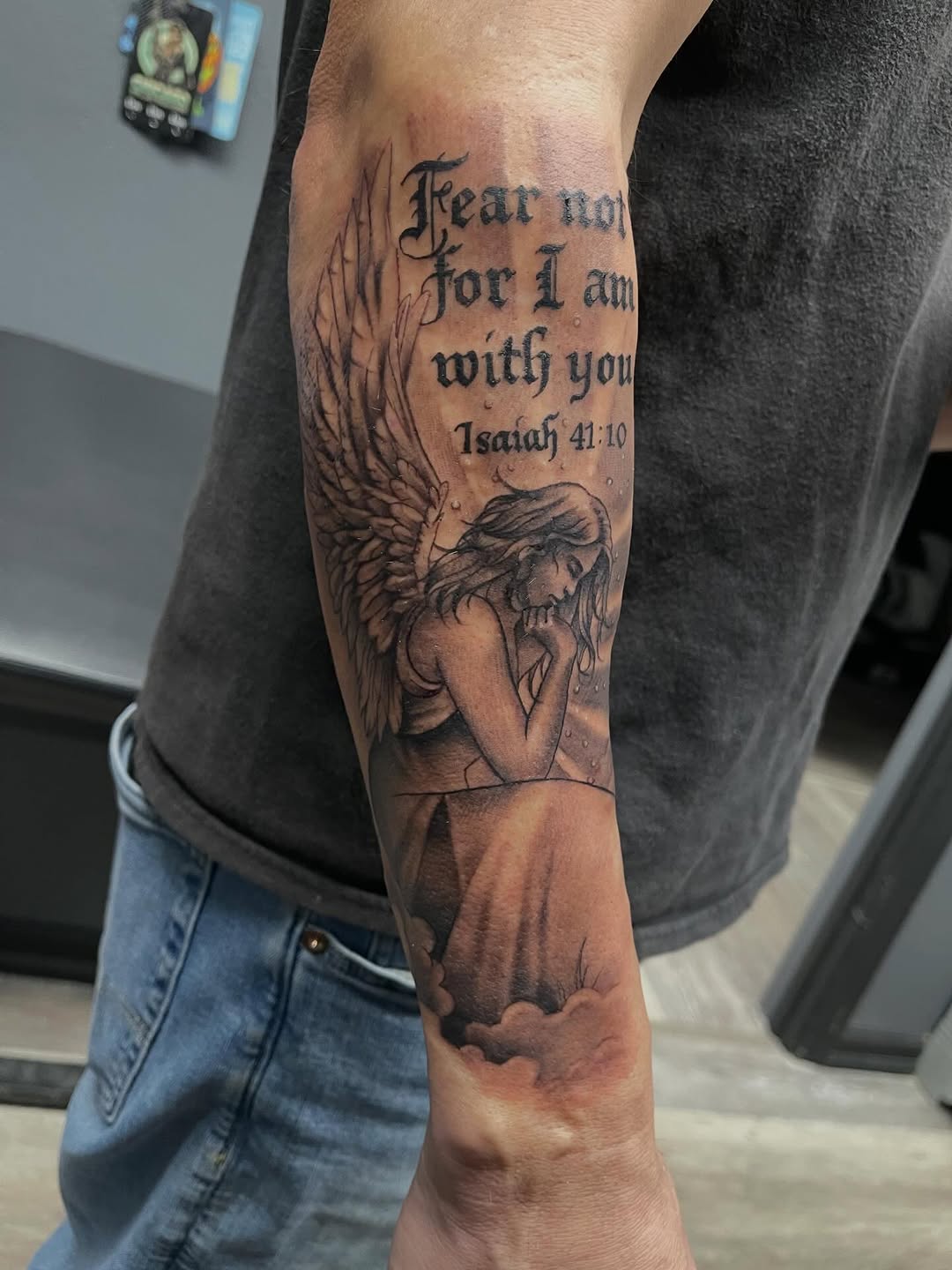 Angel with scripture realism tattoo on the forearm by Chris Torres