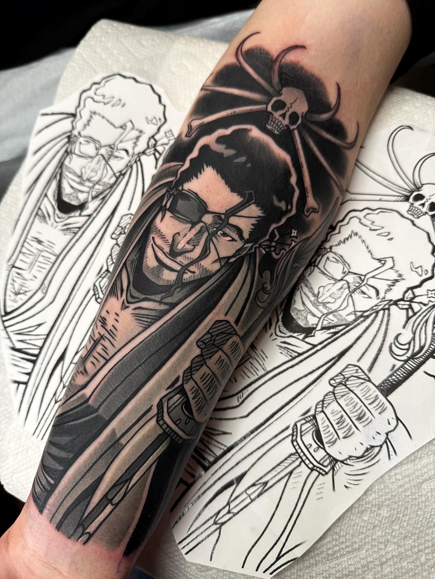 Man with sunglasses realism tattoo on the forearm by Bold Anime Tattoos