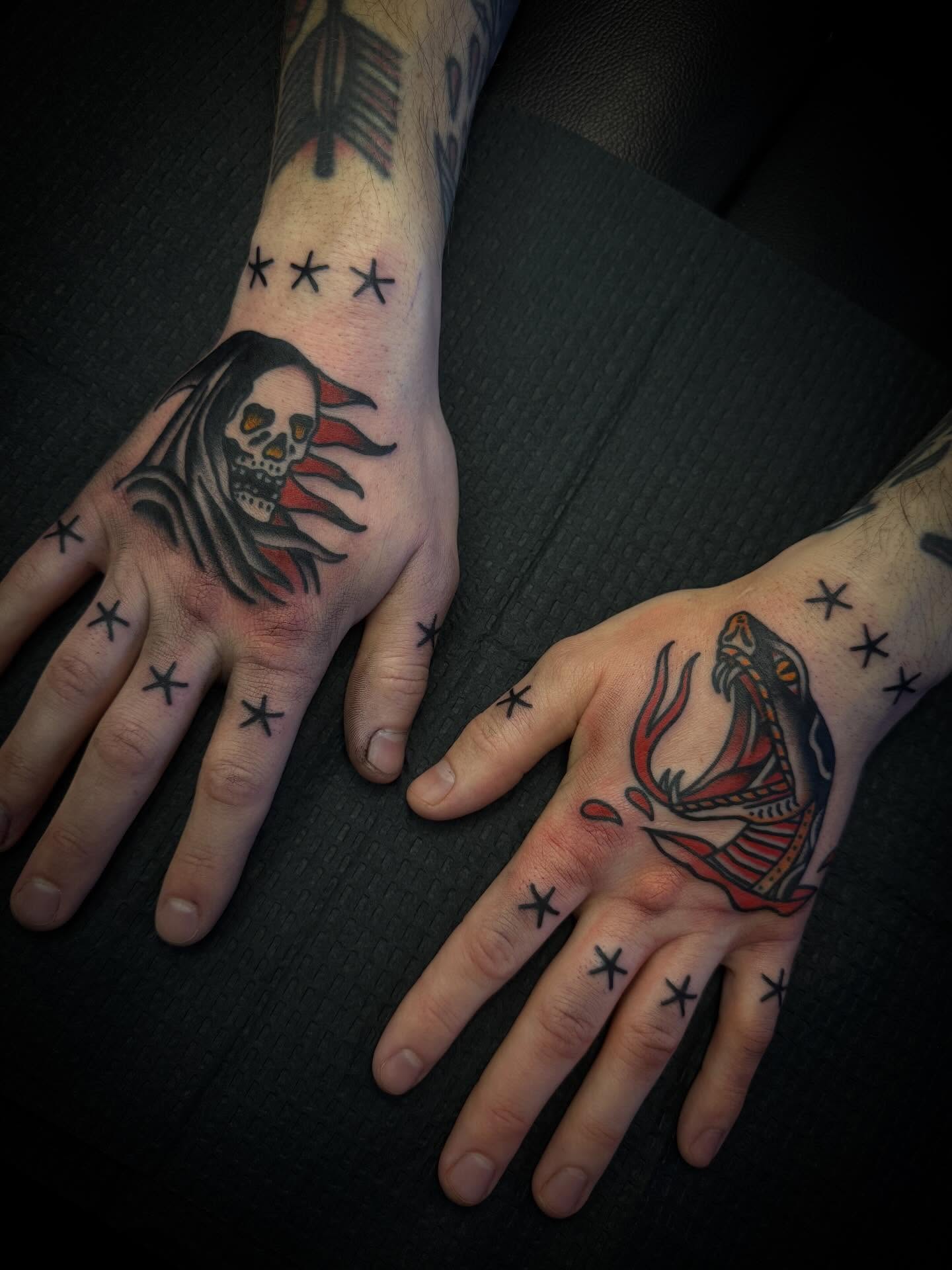 Skull and snake American traditional tattoo on the hand by Andrew Slater