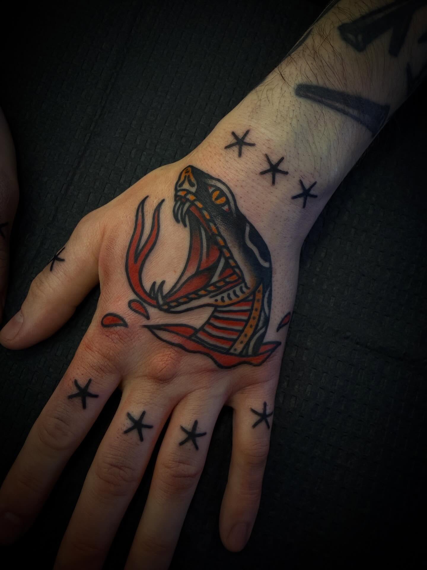 Fish American traditional tattoo on the hand by Andrew Slater