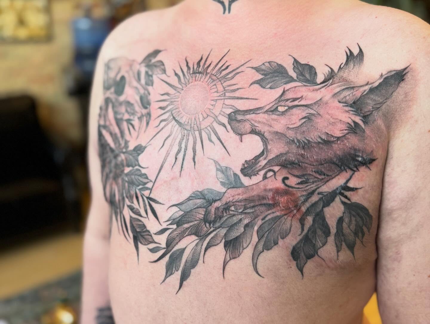 Wolf and sun realism tattoo on the back by Dre