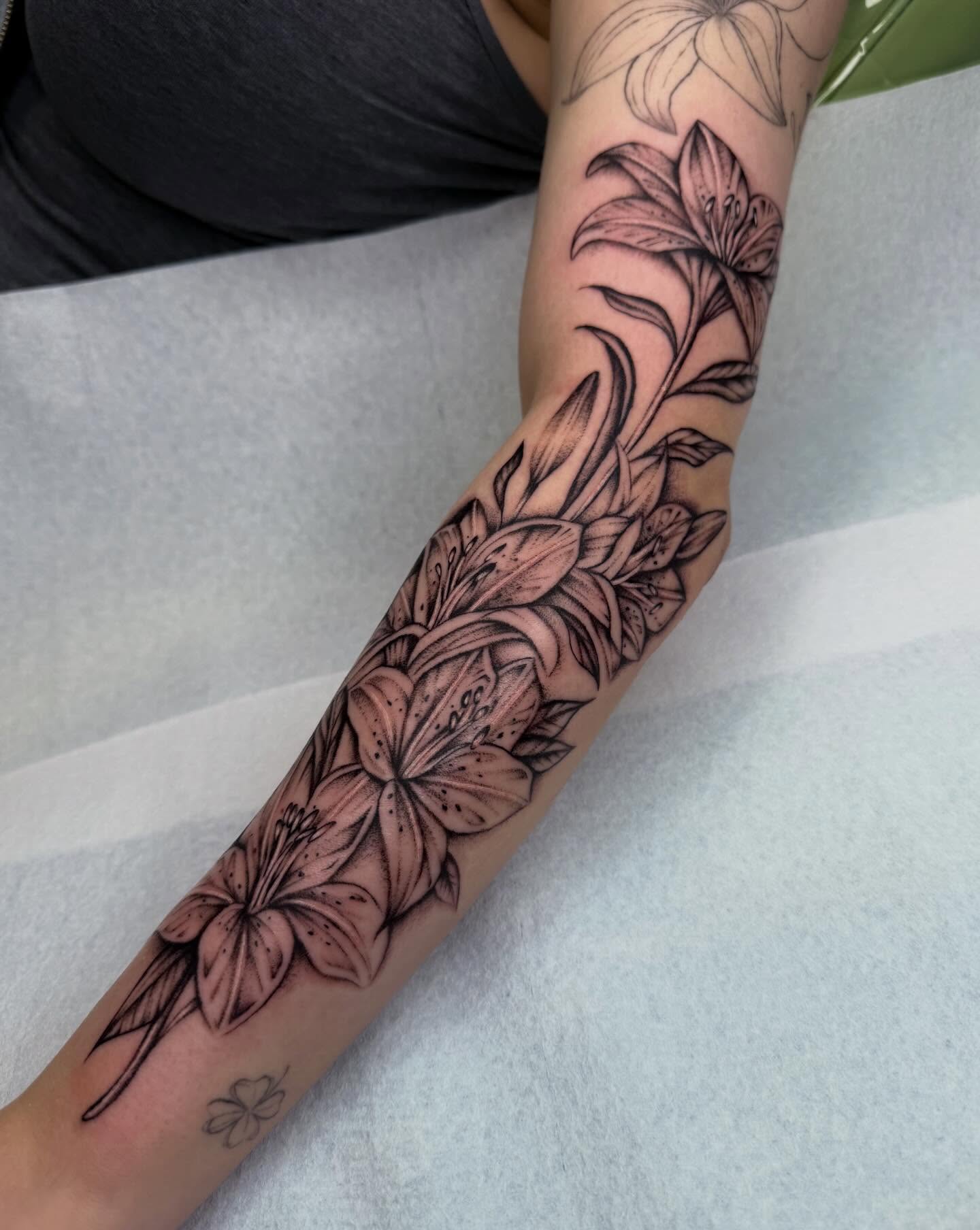 Lilies black and grey tattoo on the forearm by Nadia ★