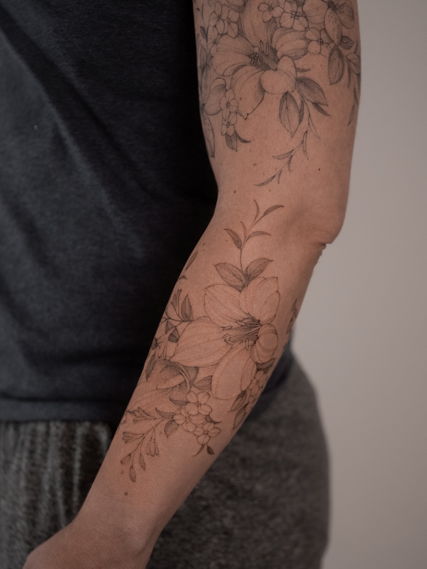 Floral bouquet black and grey tattoo on the forearm by Mary Shekh
