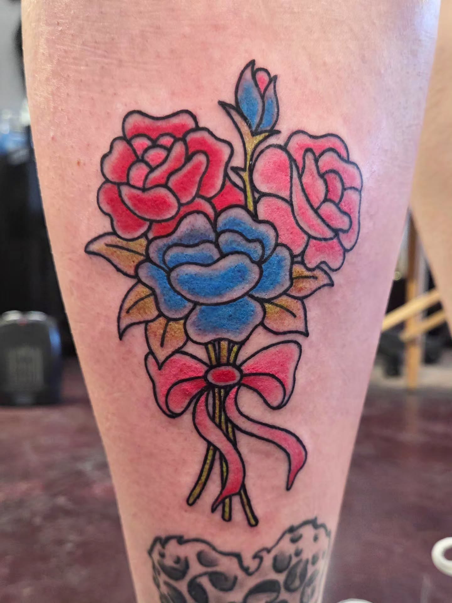 Flower bouquet American traditional tattoo on the leg by Kat Coniglio Art
